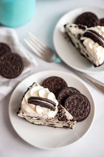 Slice of Oreo ice cream pie next to three Oreos