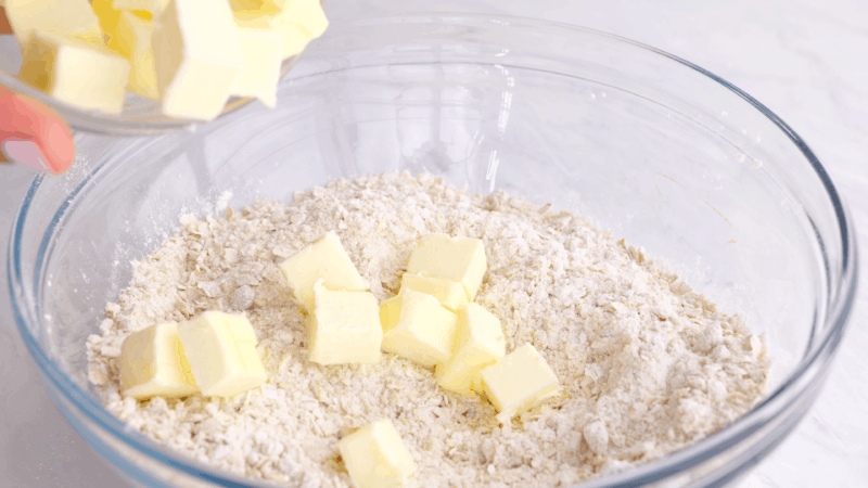 Butter slices on top of dry crisp topping ingredients.