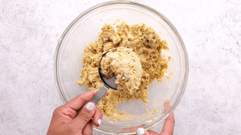 Measuring cup with salmon patty mixture.