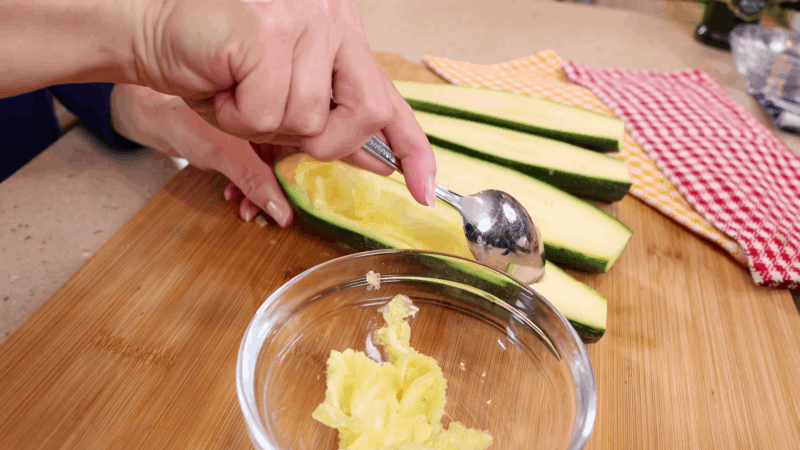 Scooping out inside of zucchini.