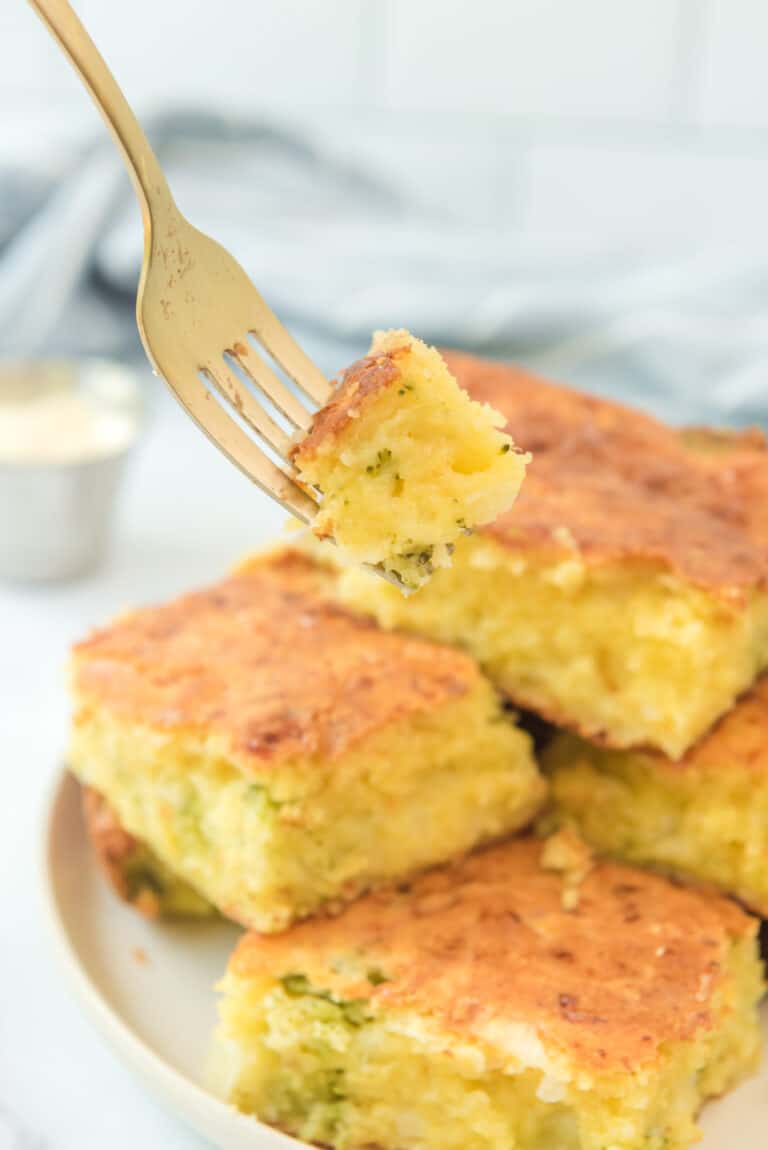 Fork with a bite of broccoli cheese cornbread.