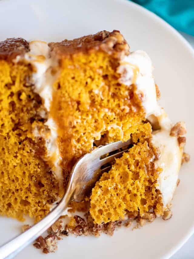 Fork in a slice of pumpkin praline cake.