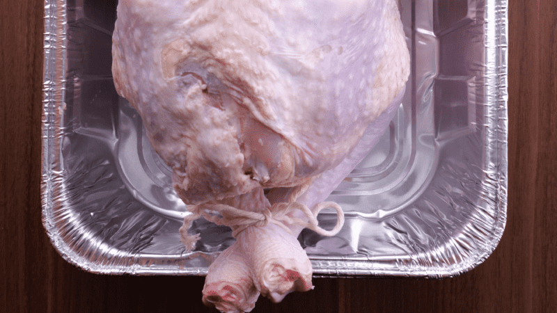 Tie turkey legs together with kitchen twine.