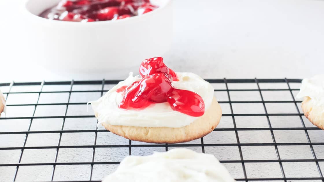 Cheesecake cookie topped with cherry pie filling.