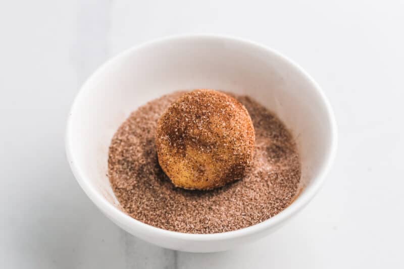 Roll each ball in the cinnamon and sugar mixture.