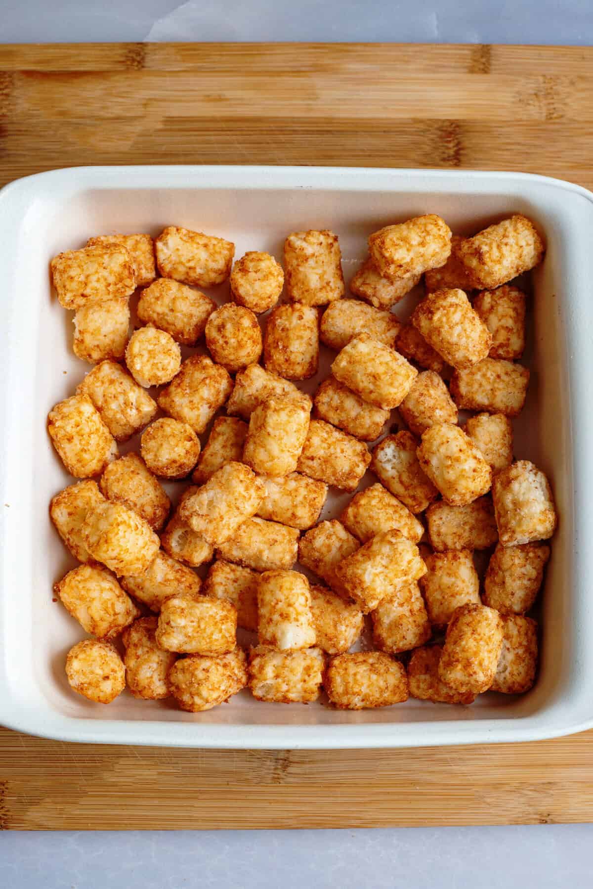 place tater tots in the bottom of the dish