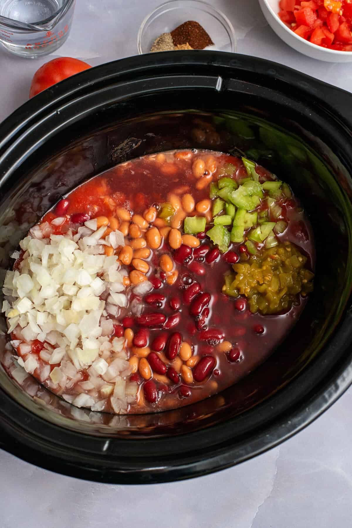 Add chopped celery, onion and tomatoes to crock pot