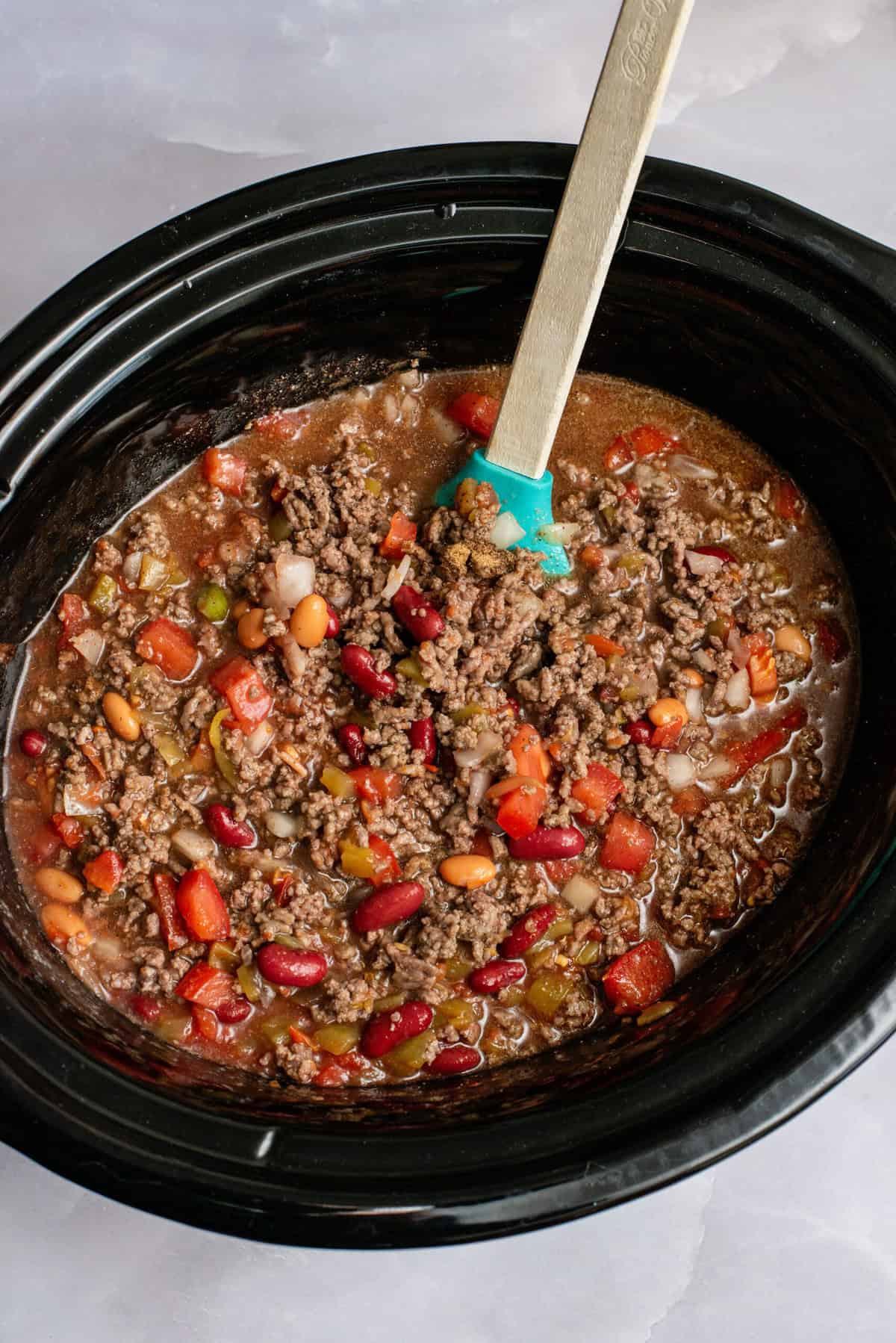 Stir Crock Pot Chili ingredients together.