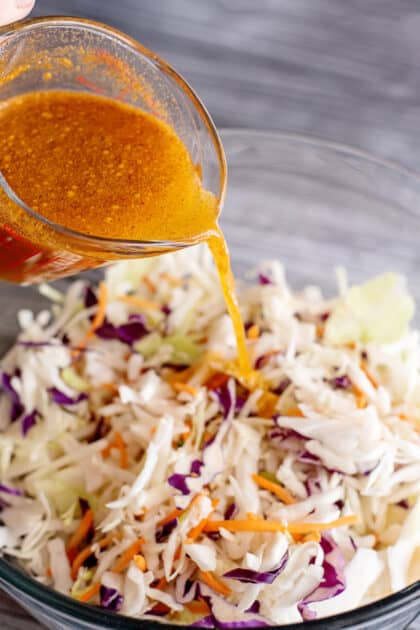 Pour mixture over coleslaw in bowl.