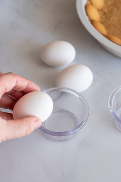 Tap egg on bowl gently to crack it/
