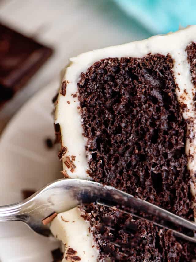 A fork breaking off a piece of chocolate velvet cake.