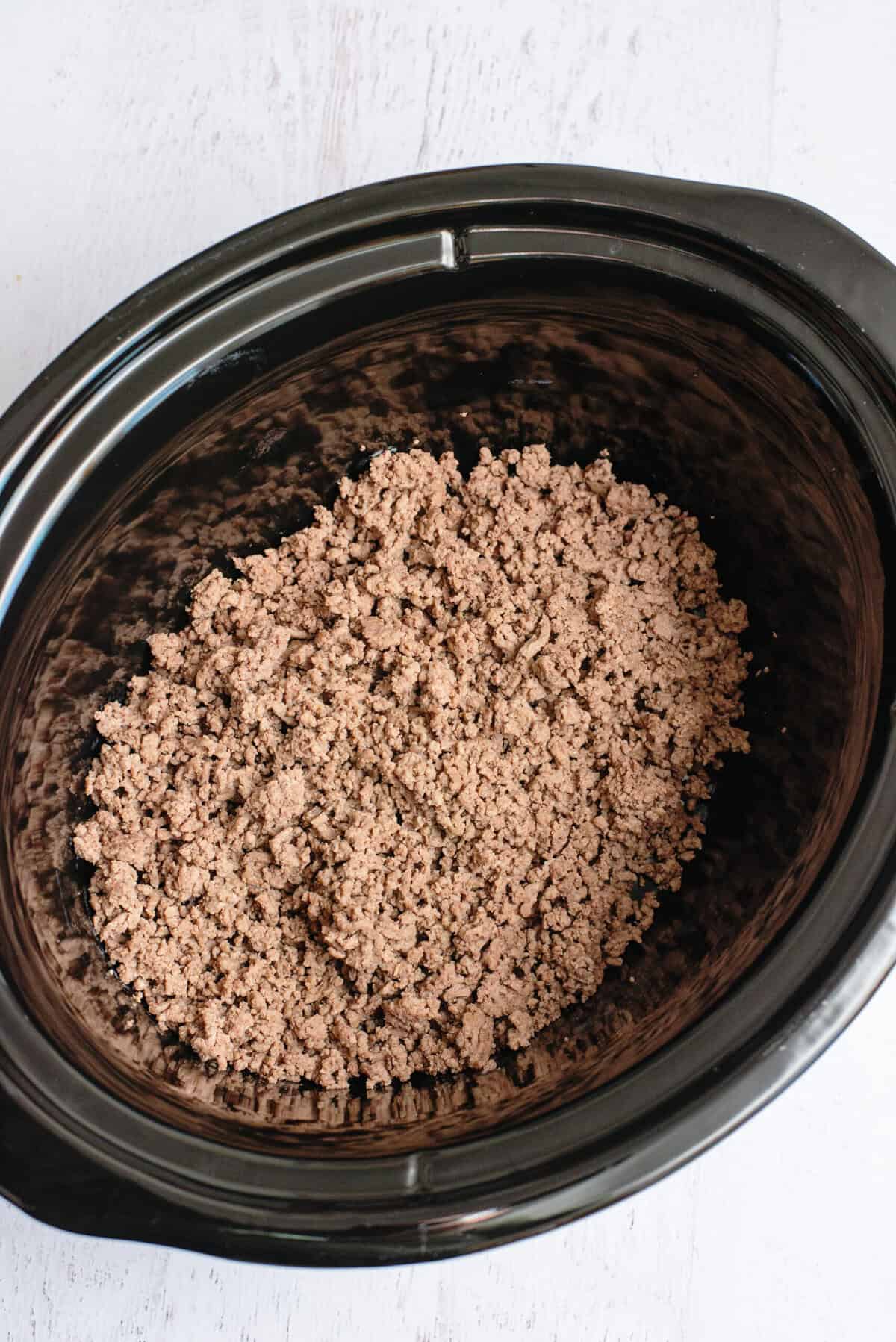 Put browned ground beef in the bottom of a slow cooker insert