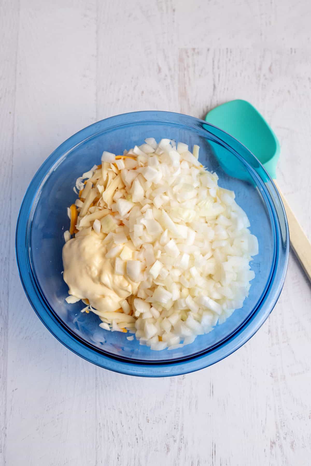 Add chopped onion to mixing bowl.