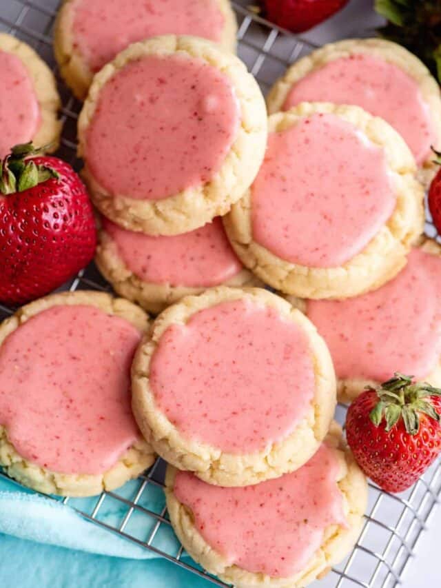 Stack of strawberry frosted cookies.