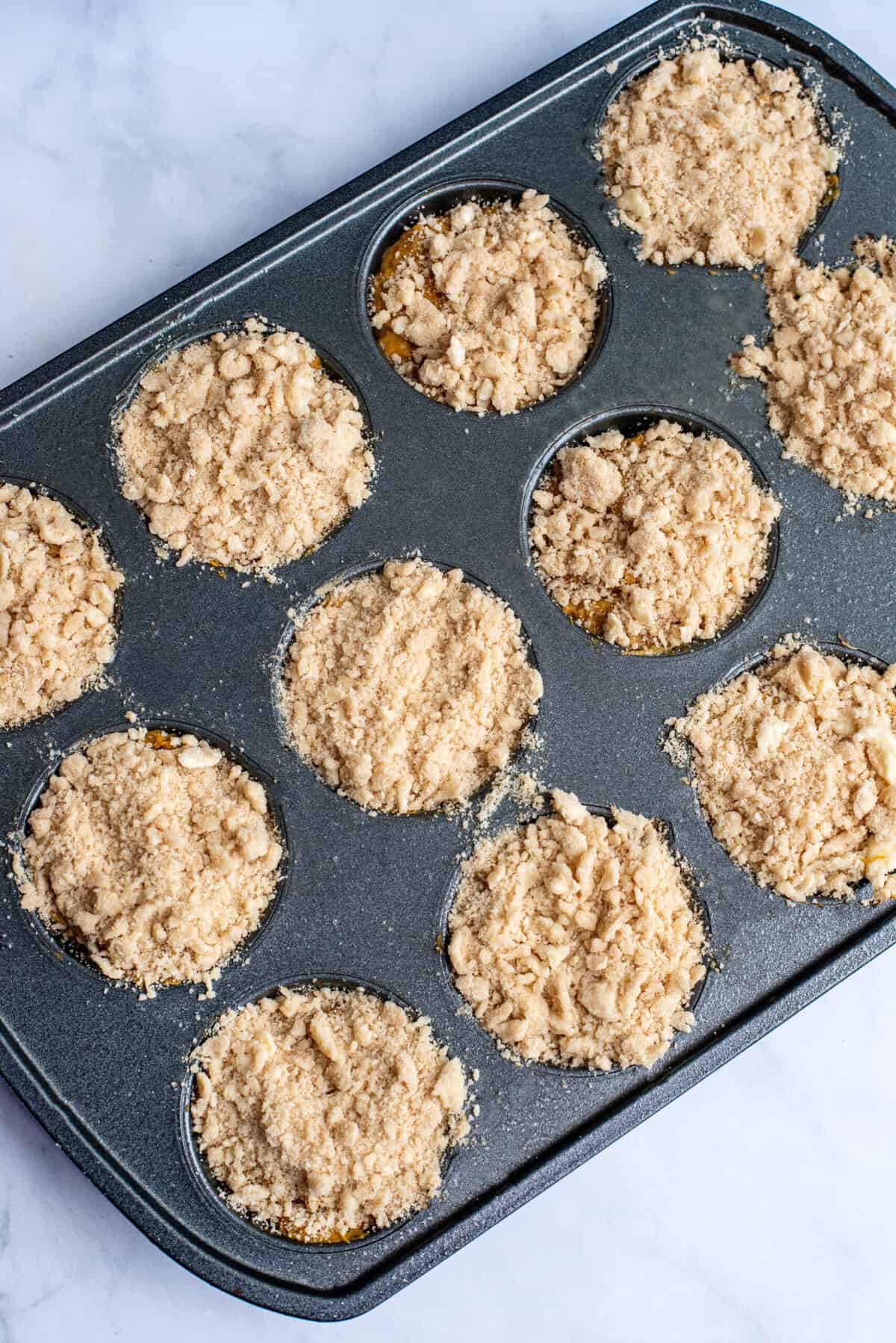 sprinkle topping over the prepared muffins