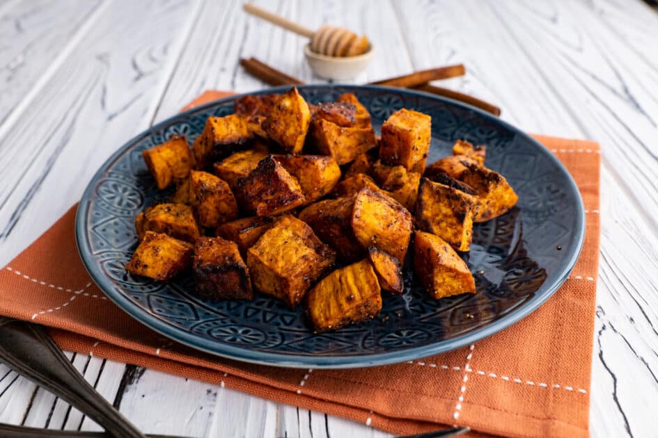 Plate of honey roasted sweet potato with cinnamon.