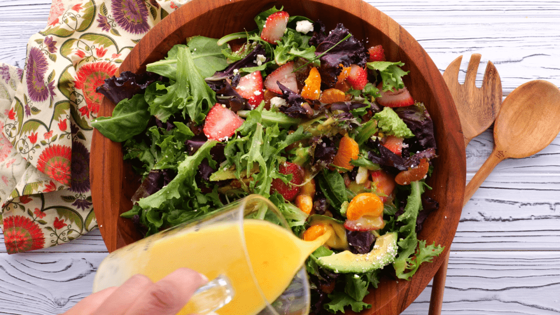 Pour dressing over strawberry salad.