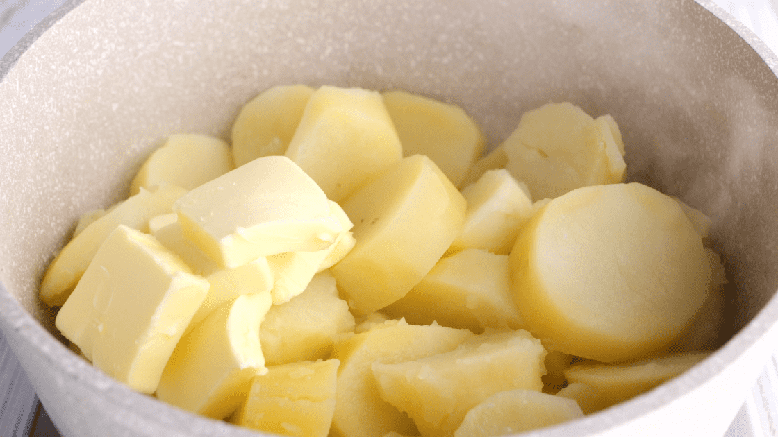 Place potatoes back in pot with butter.