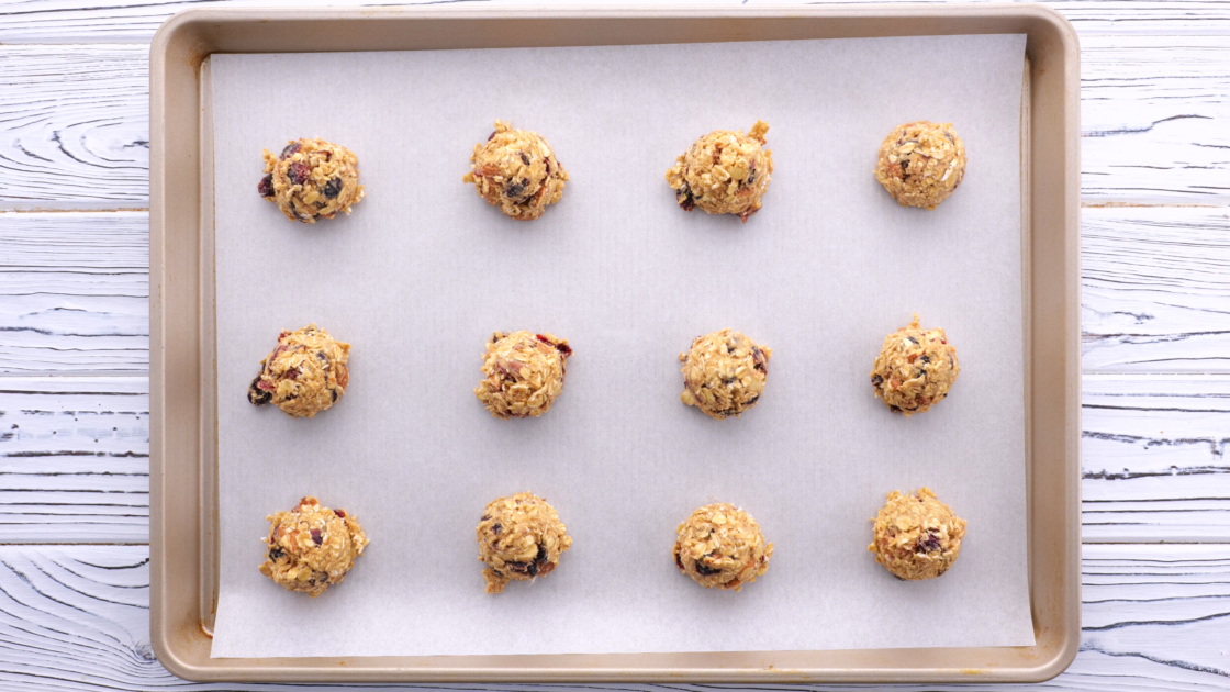 Form dough into balls and place on prepared baking sheet.