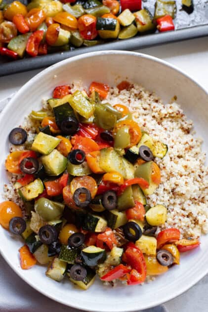 Add roasted vegetables to large bowl with quinoa and olives.