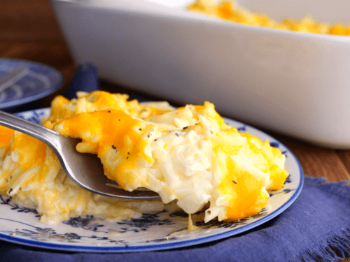 Forkful of cheesy hashbrown casserole.