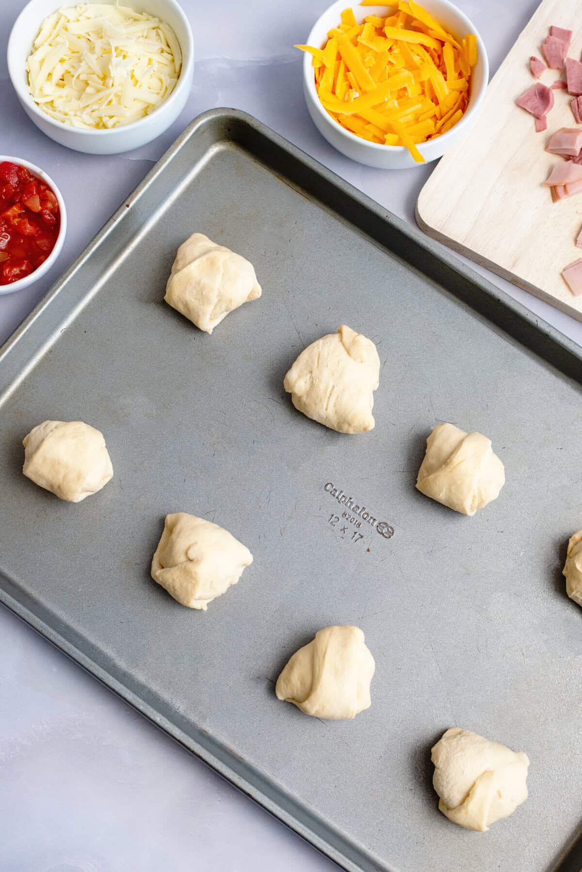 place rolls on prepared baking sheet