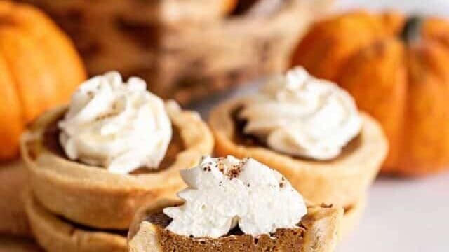 Stack of mini pumpkin pies.