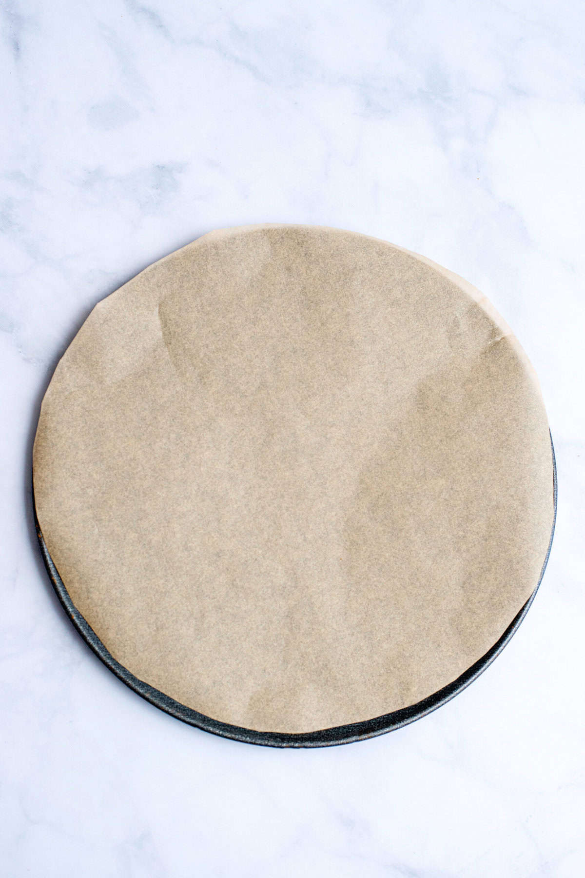 Line pizza pan with parchment for Cheesy Pull Apart Bread Christmas Wreath