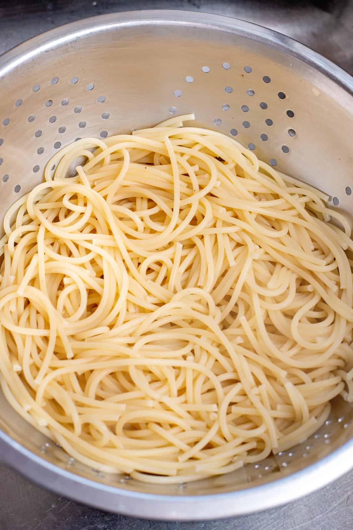 Boil and drain spaghetti noodles for Baked Spaghetti