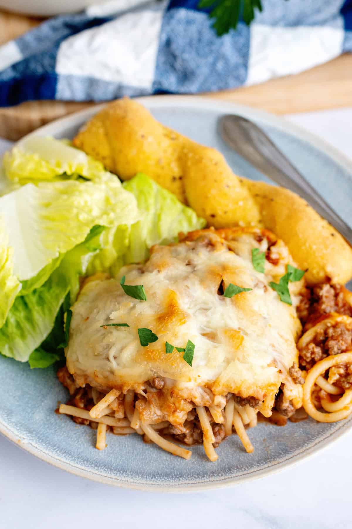 Baked Spaghetti portion with bread