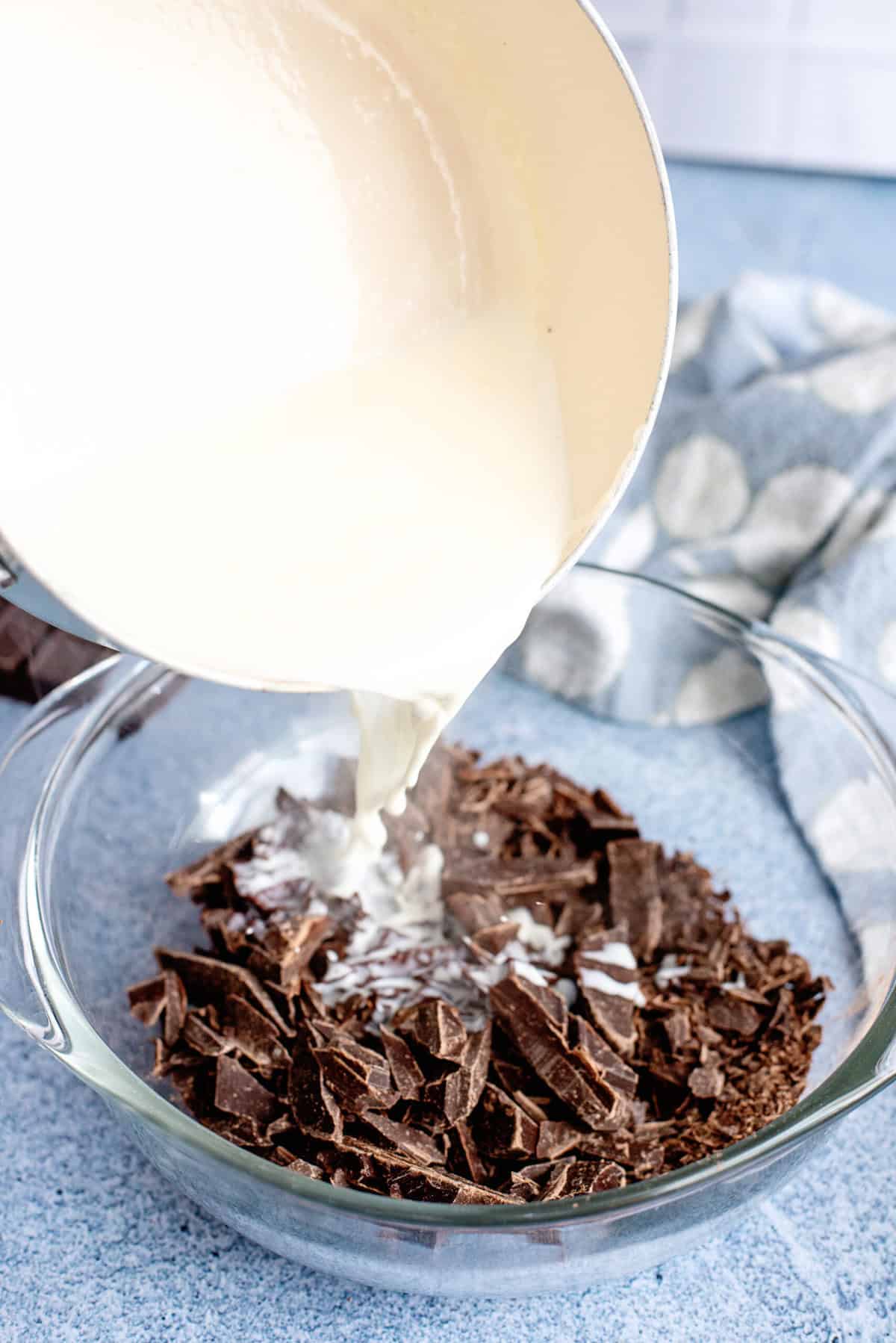 Warm cream and pour over chopped chocolate