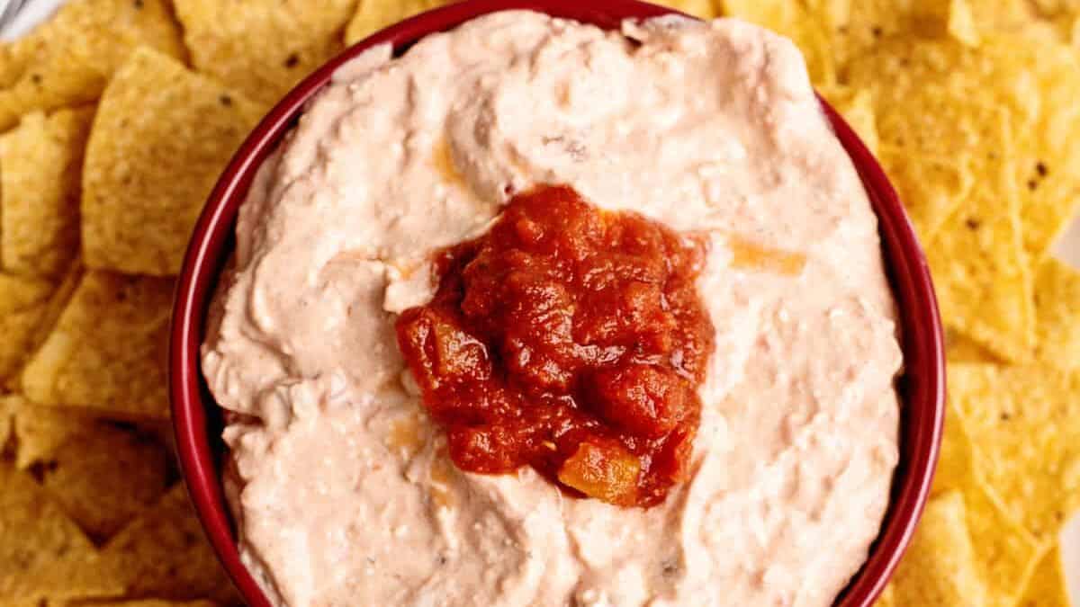 Cream cheese salsa dip surrounded by tortilla chips.