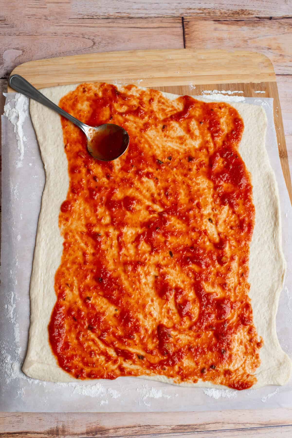 Spread Marinara over dough