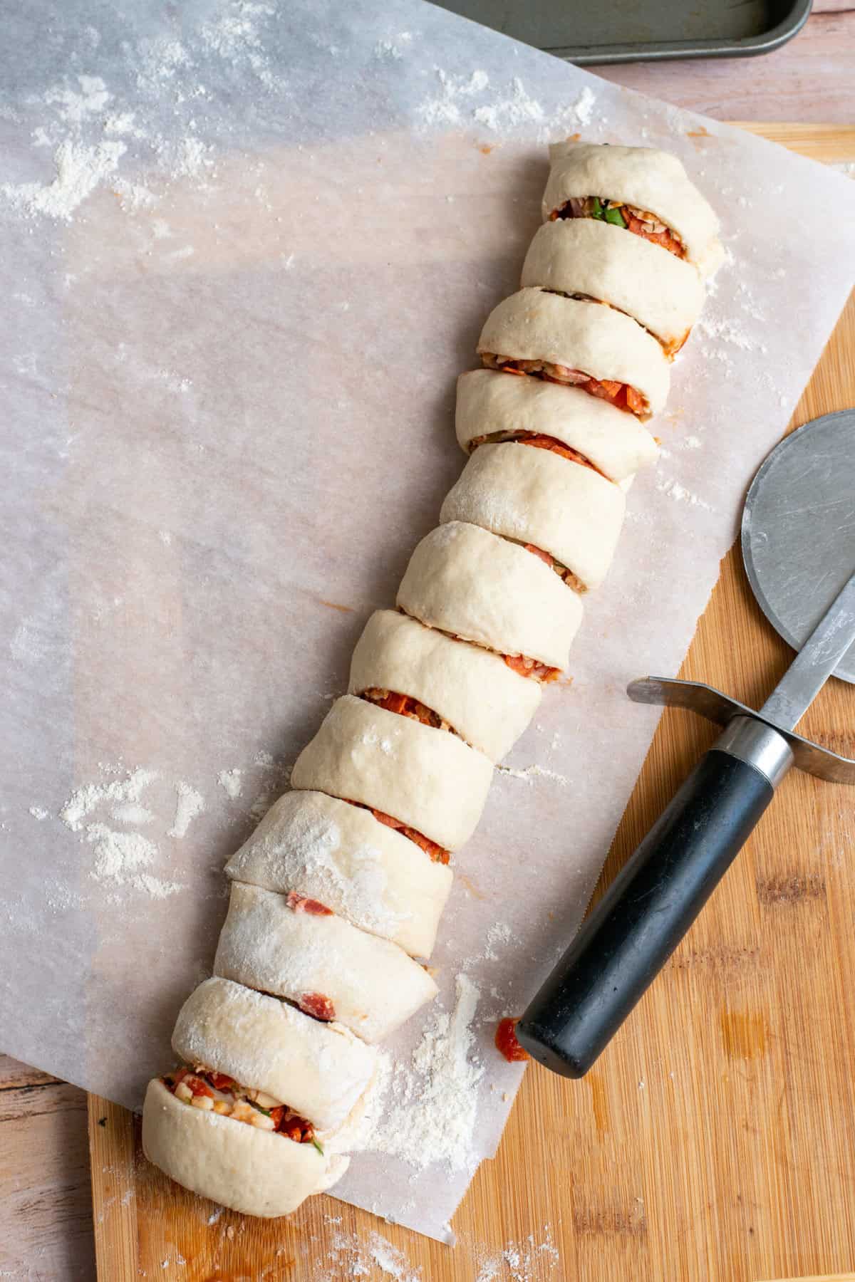 Cut Pepperoni Pizza Rolls with pizza cutter