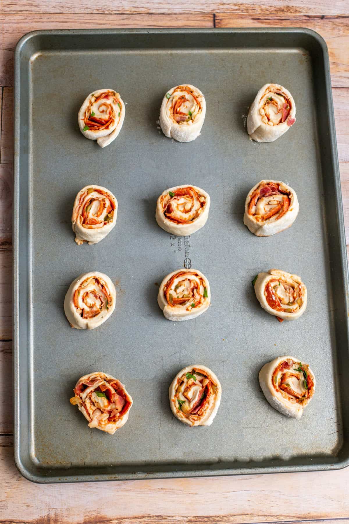 Place pizza rolls on prepared baking sheet