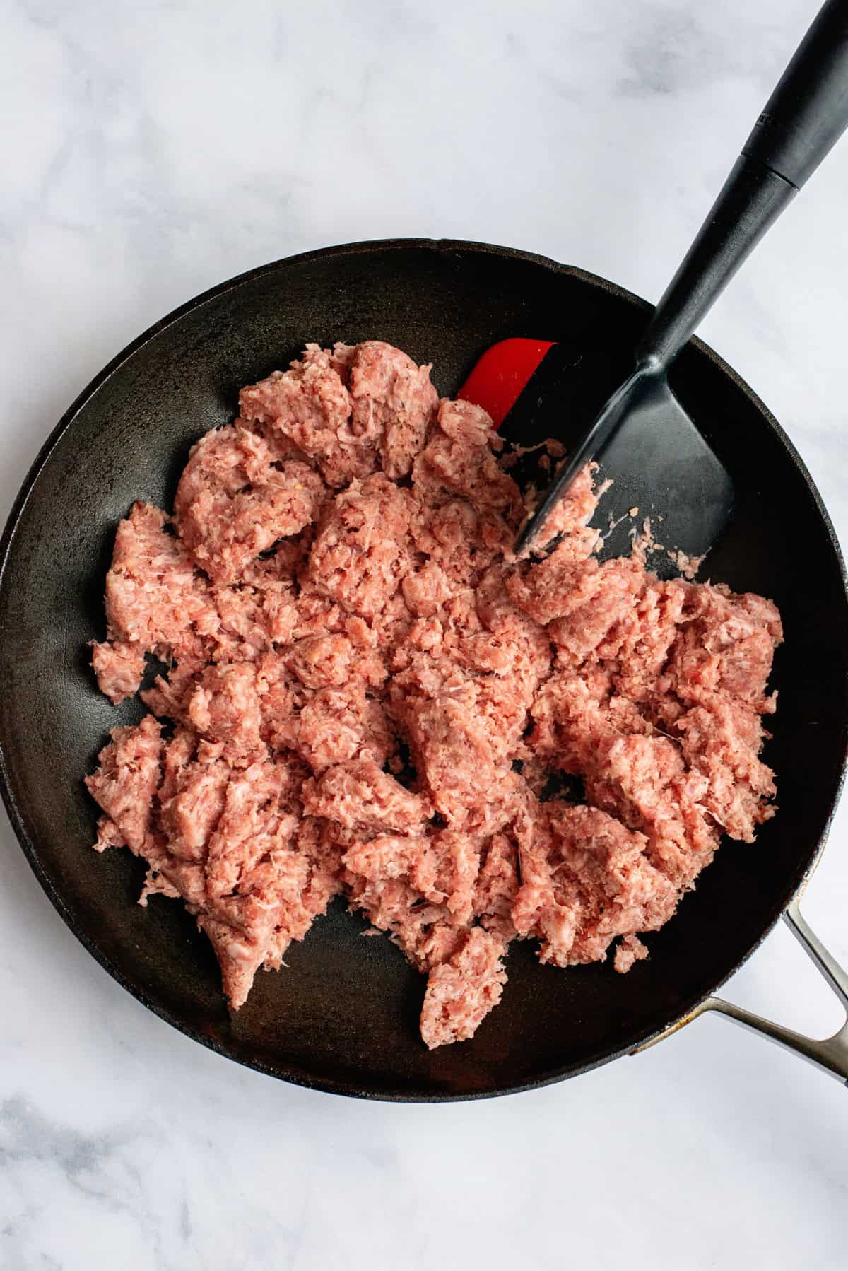 Fry sausage in skillet