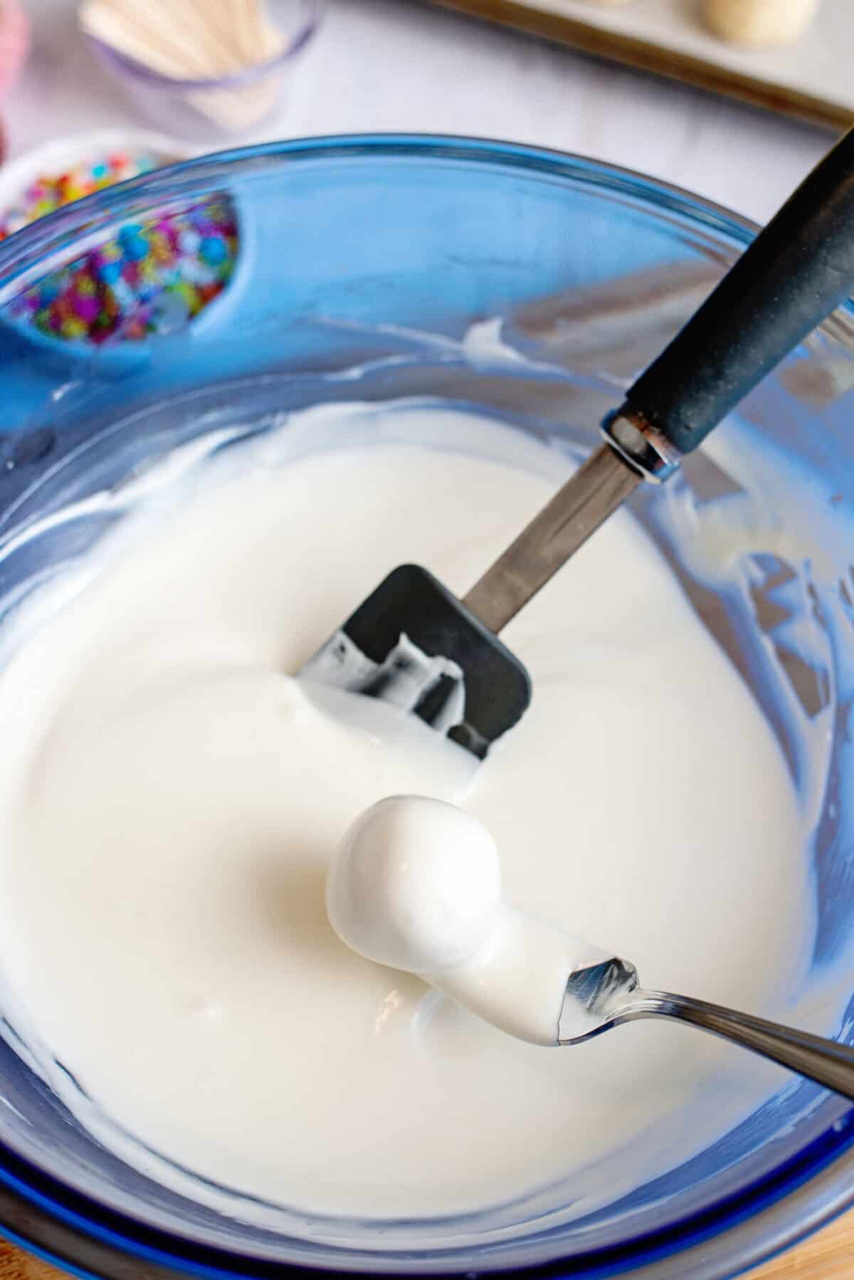 Dip dough balls into almond bark coating