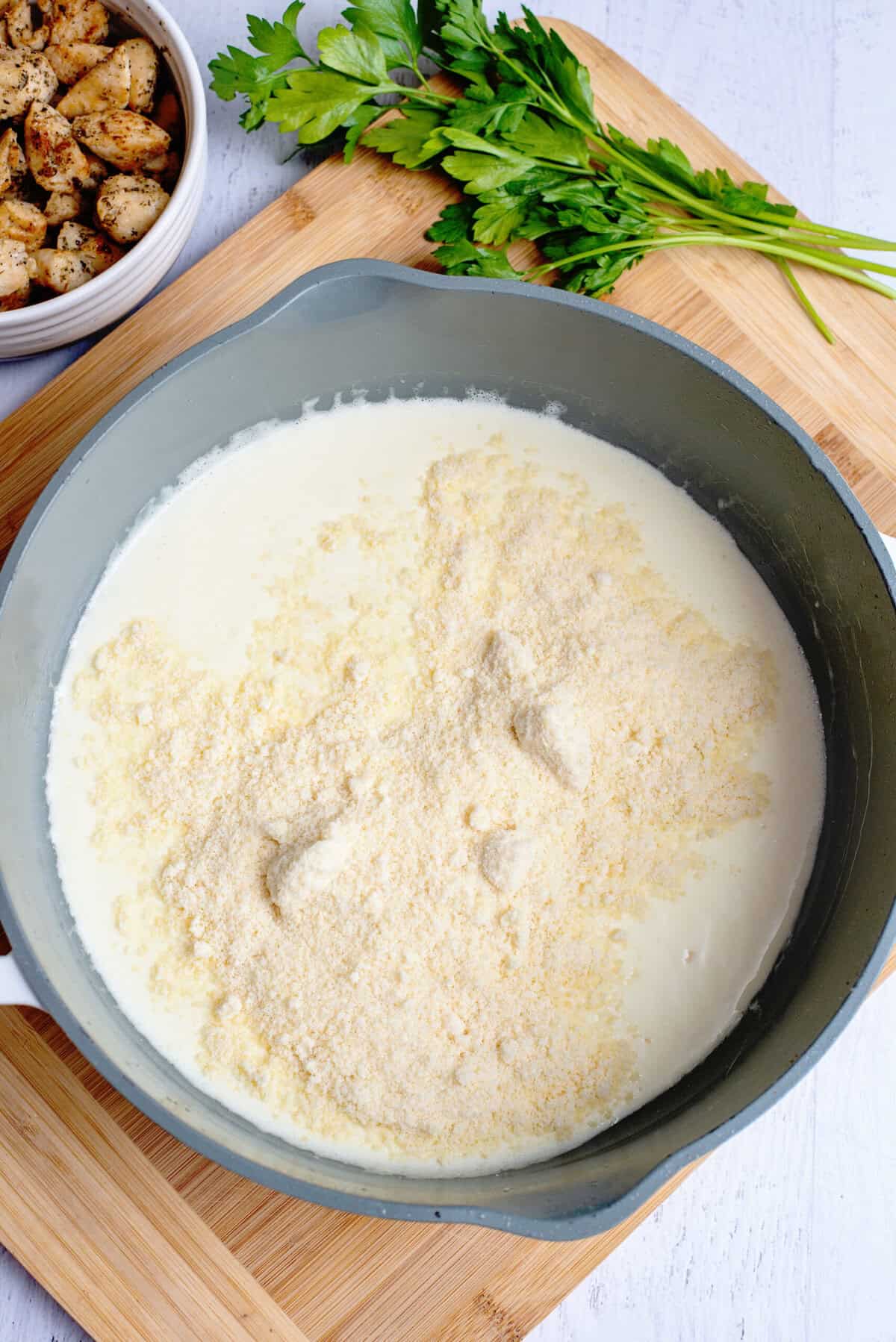 Stir parmesan cheese into the warmed milk and butter