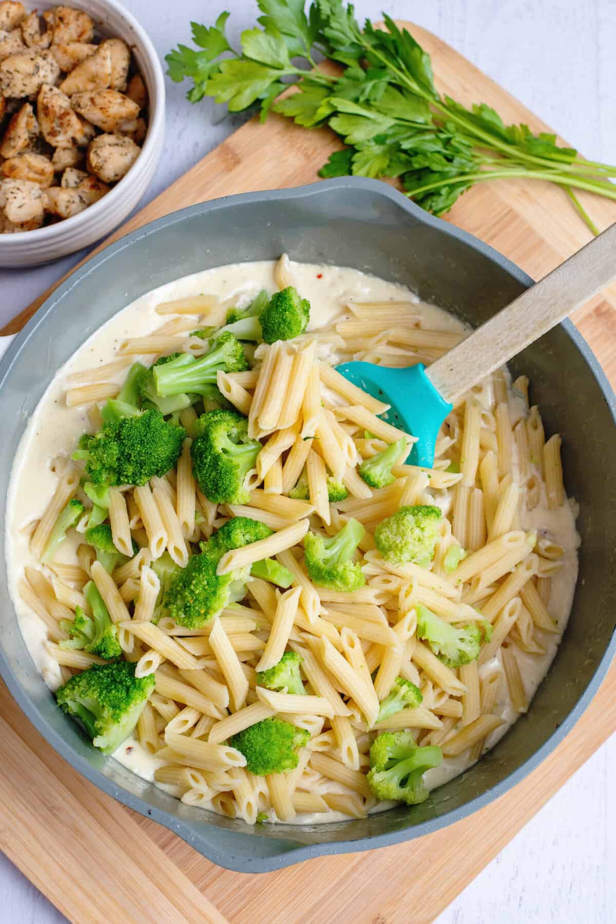 Add pasta and broccoli into sauce