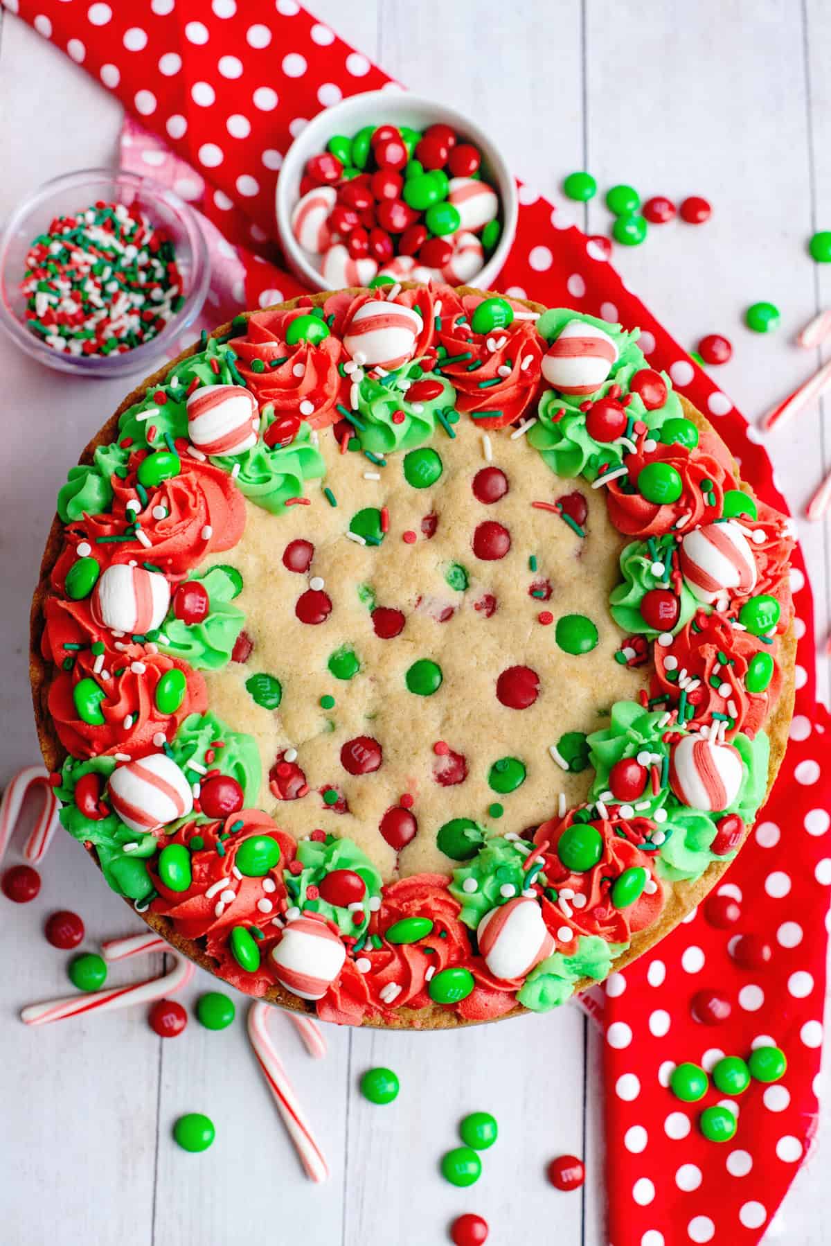 Add extra M&M's to finish Christmas Sugar Cookie Cake