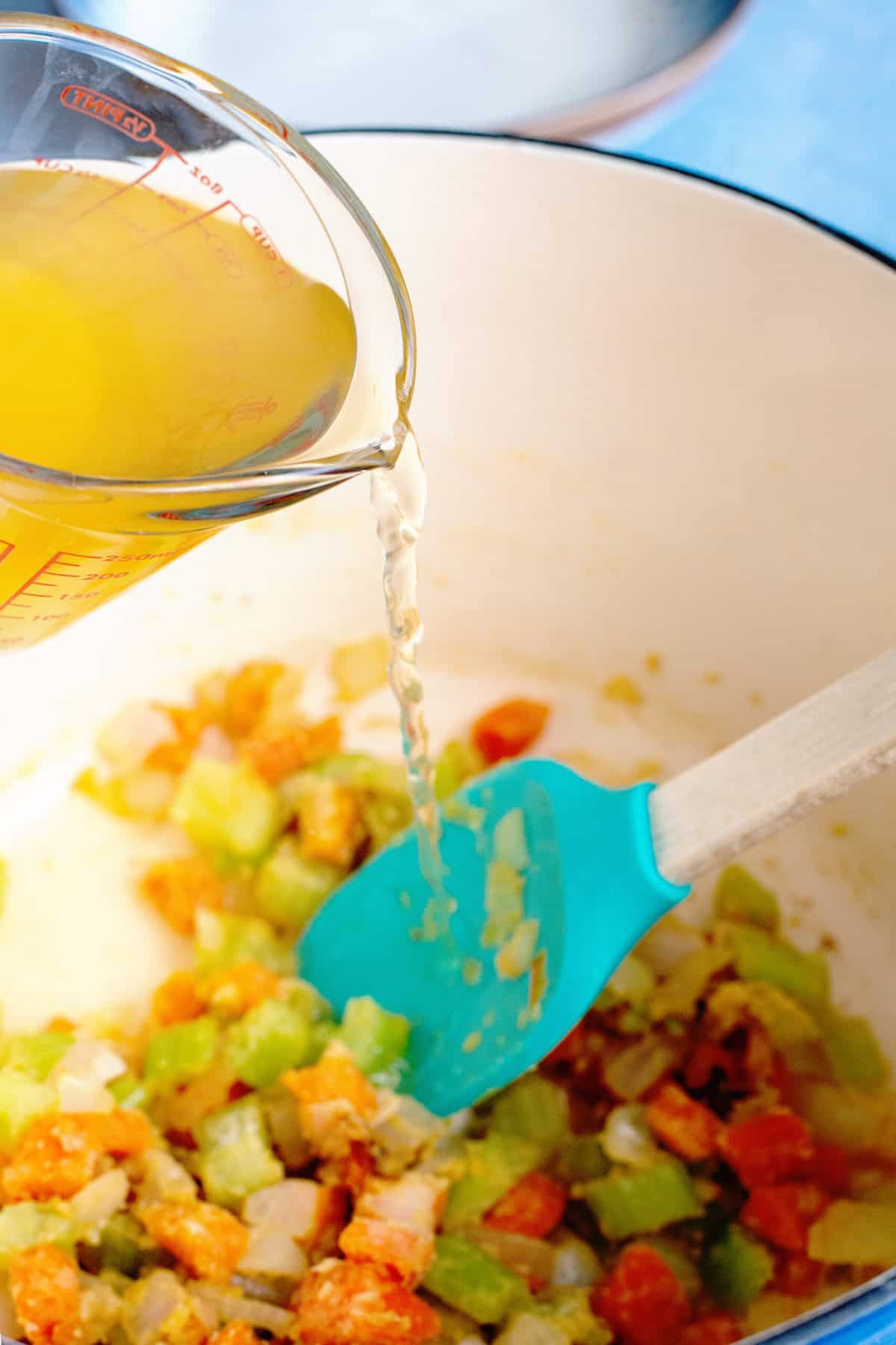 whisk broth into floured vegetables