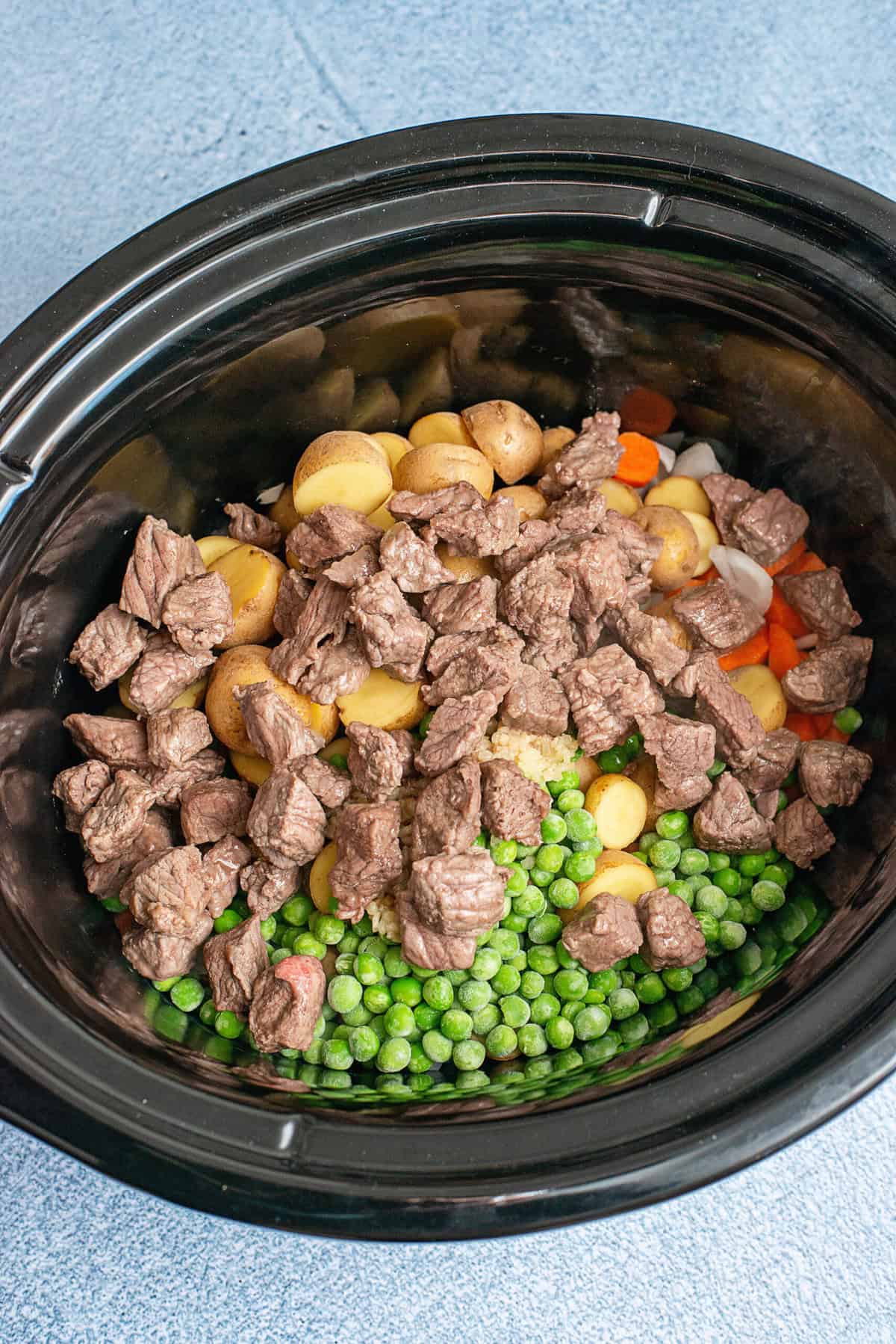 Add meat over vegetables in crockpot