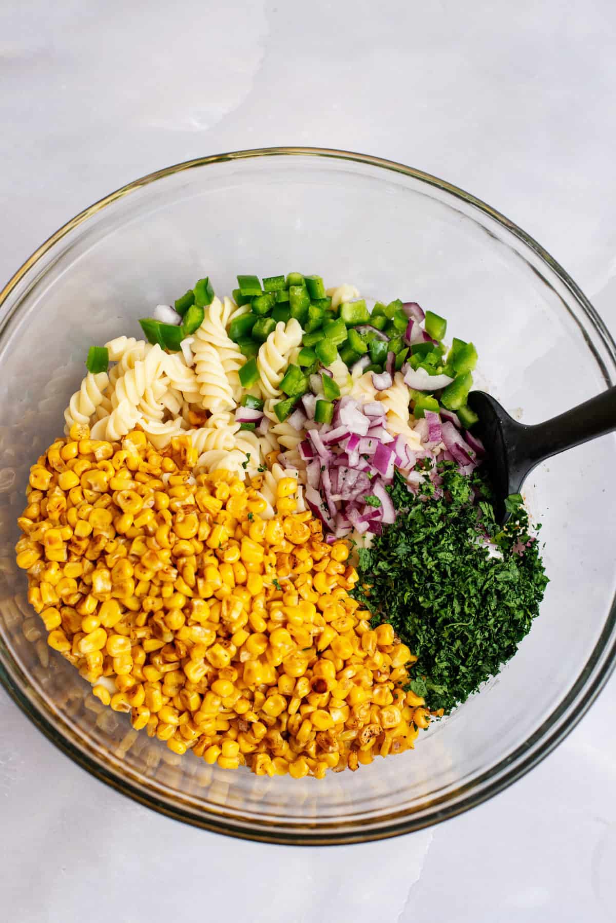 Add pasta, onion, jalapeño and cilantro to the dressing.