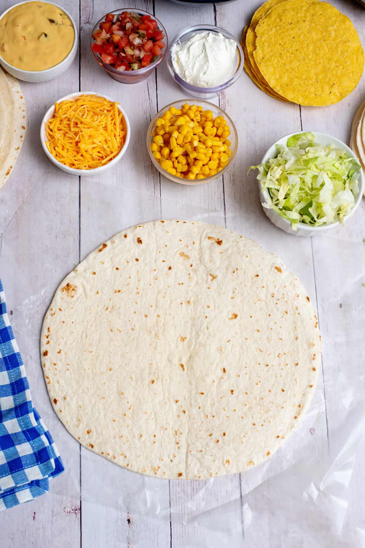 lay out burrito size tortilla for toppings