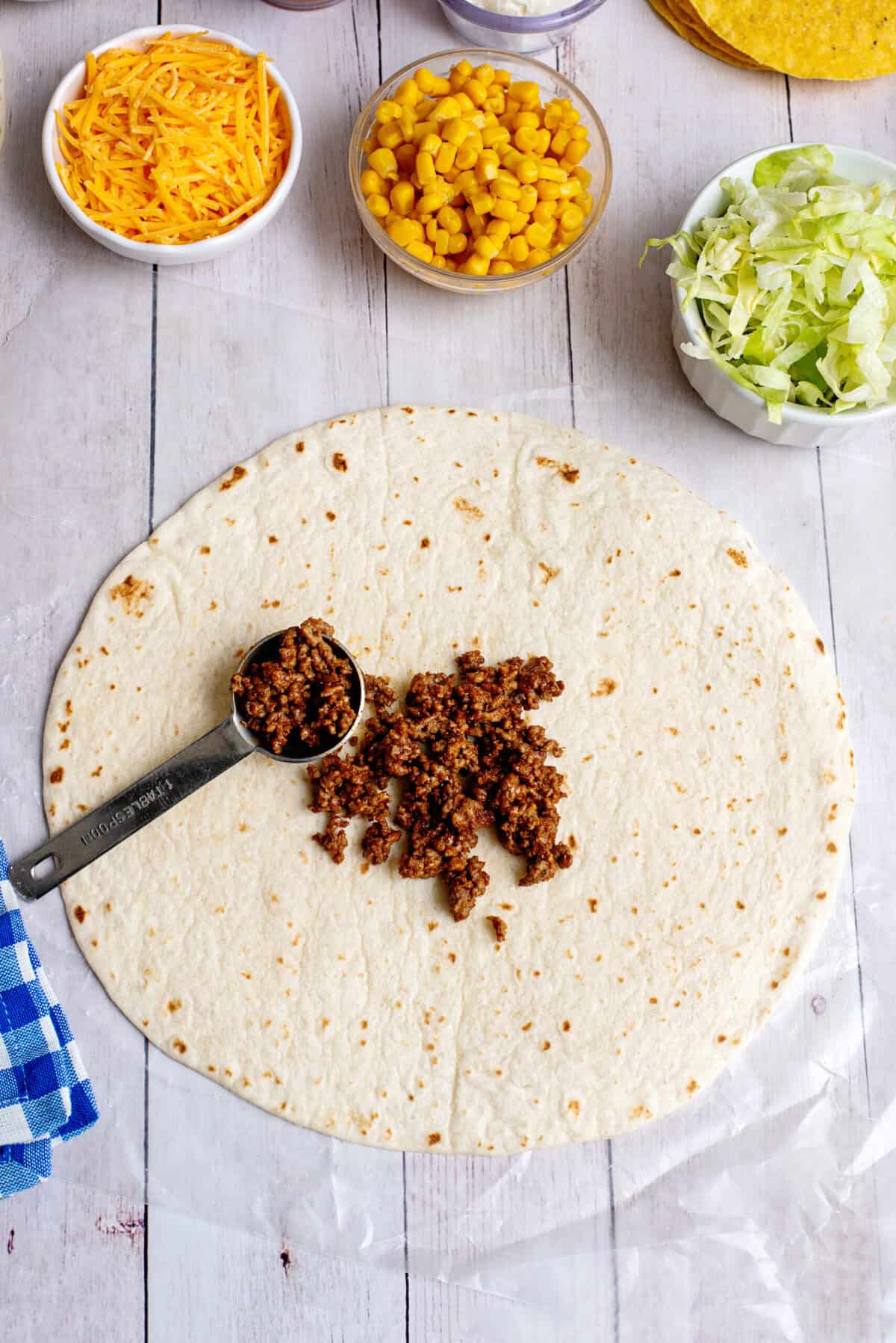 Add ground beef to tortilla