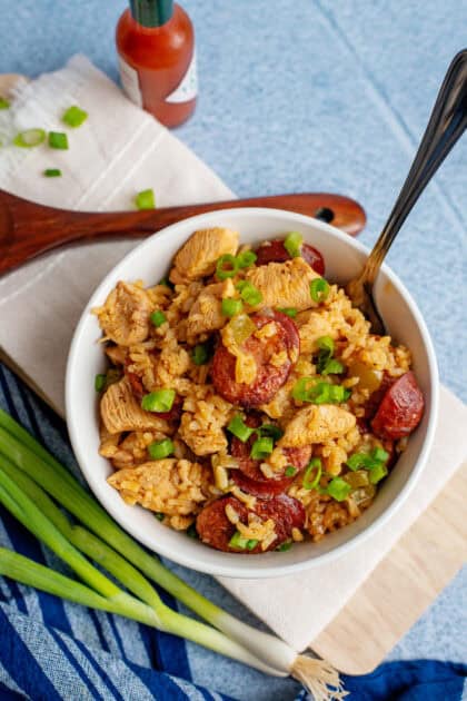 Rich, flavorful jambalaya with andouille, chicken, and rice in a white serving bowl.